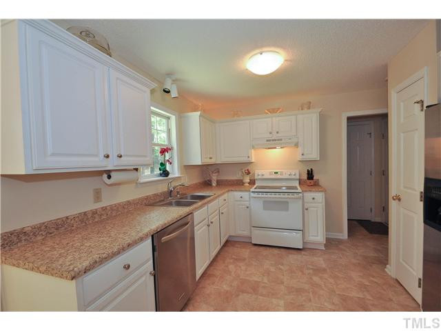 223 Ridge Drive Garner, NC 27529 - Photo 7 of 20 Great cook friendly kitchen with updated counter tops and vinyl flooring, stainless steel dishwasher and refrigerator, brand new sink and faucet, and wonderful new lighting Kitchen