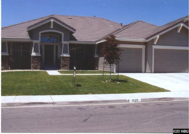 1525 Diamond Country Drive Reno, NV 89521 - Photo 1 of 6 a front view of a house with a yard and garage