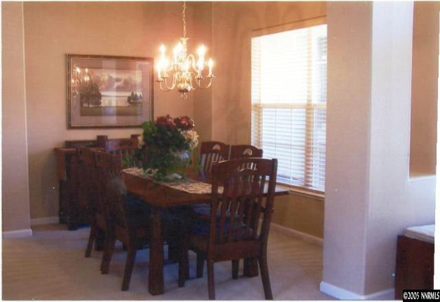 1525 Diamond Country Drive Reno, NV 89521 - Photo 4 of 6 a view of a dining room with furniture and chandelier