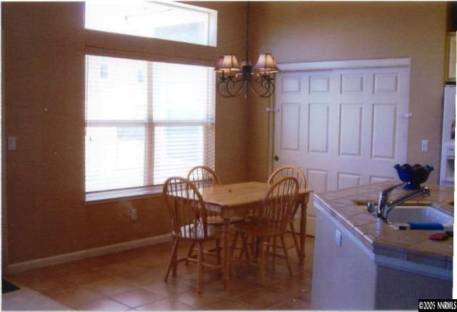 1525 Diamond Country Drive Reno, NV 89521 - Photo 6 of 6 a kitchen with granite countertop sink table and chairs