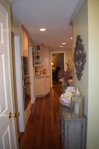 a view of a hallway to dining room and wooden floor