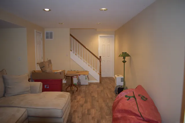 a view of a livingroom with furniture and staircase