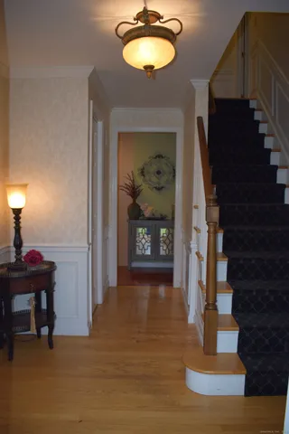 a view of a livingroom with furniture a dinning room and stairs