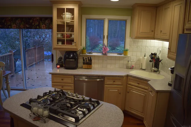 a kitchen with a stove a sink and cabinets