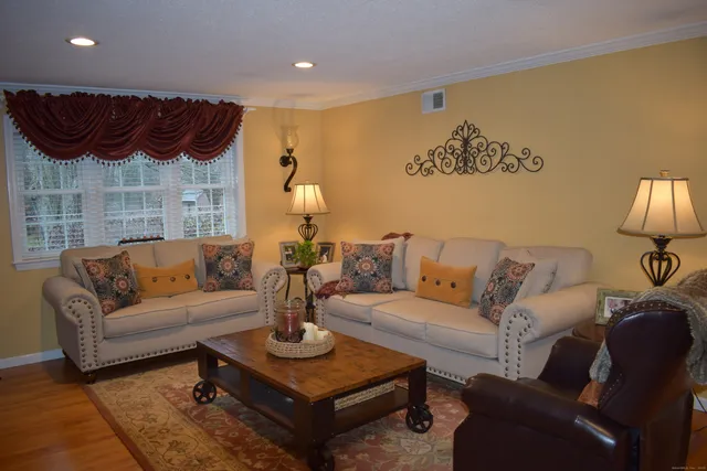 a living room with furniture and a lamp