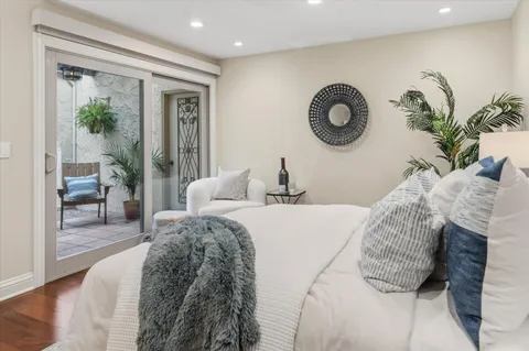 a bedroom with a bed and a painting on the wall