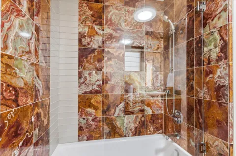 a bathroom with a toilet and shower