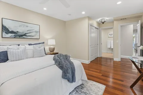 a bedroom with a bed and a painting on the wall