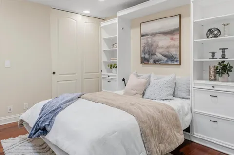 a bedroom with a large bed and a chandelier