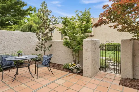 a view of a backyard with a tub and seating space