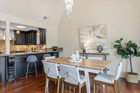 a dining room with furniture and wooden floor