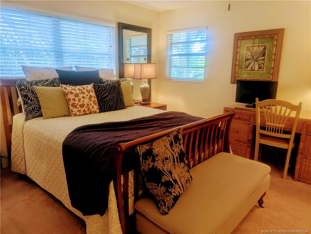 2950 Southeast Ocean Boulevard, Unit 56 Stuart, FL 34996 - Photo 5 of 12 a bedroom with a bed and a television