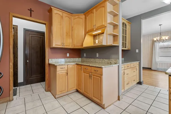 a kitchen with stainless steel appliances granite countertop a refrigerator and a stove
