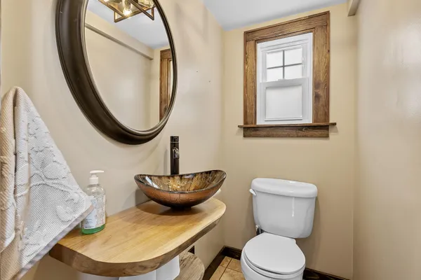 a bathroom with a toilet a sink and a mirror