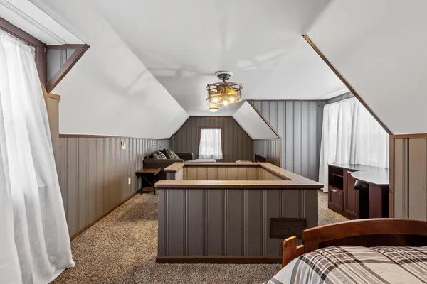 a view of bedroom with furniture and staircase