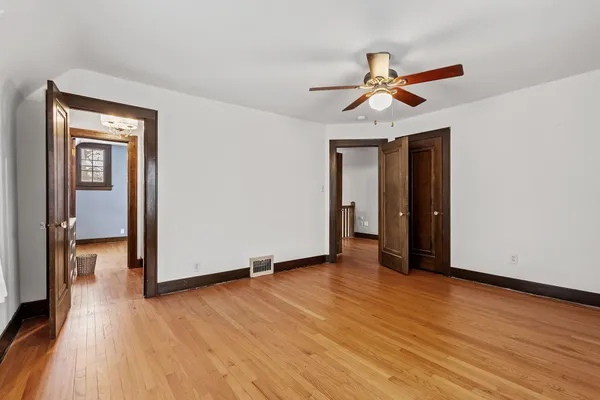 a view of empty room with wooden floor