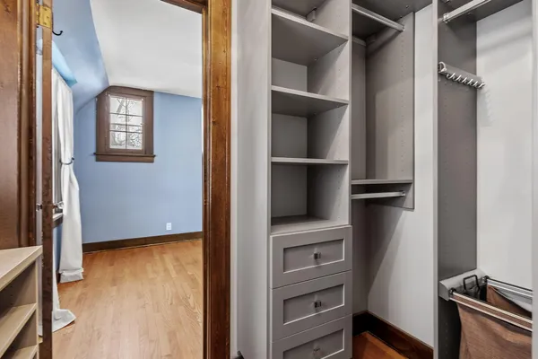 a view of walk in closet with empty racks