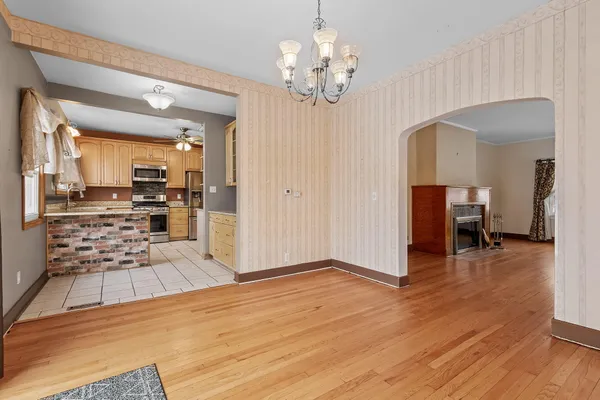 a view of a room with wooden floor and furniture