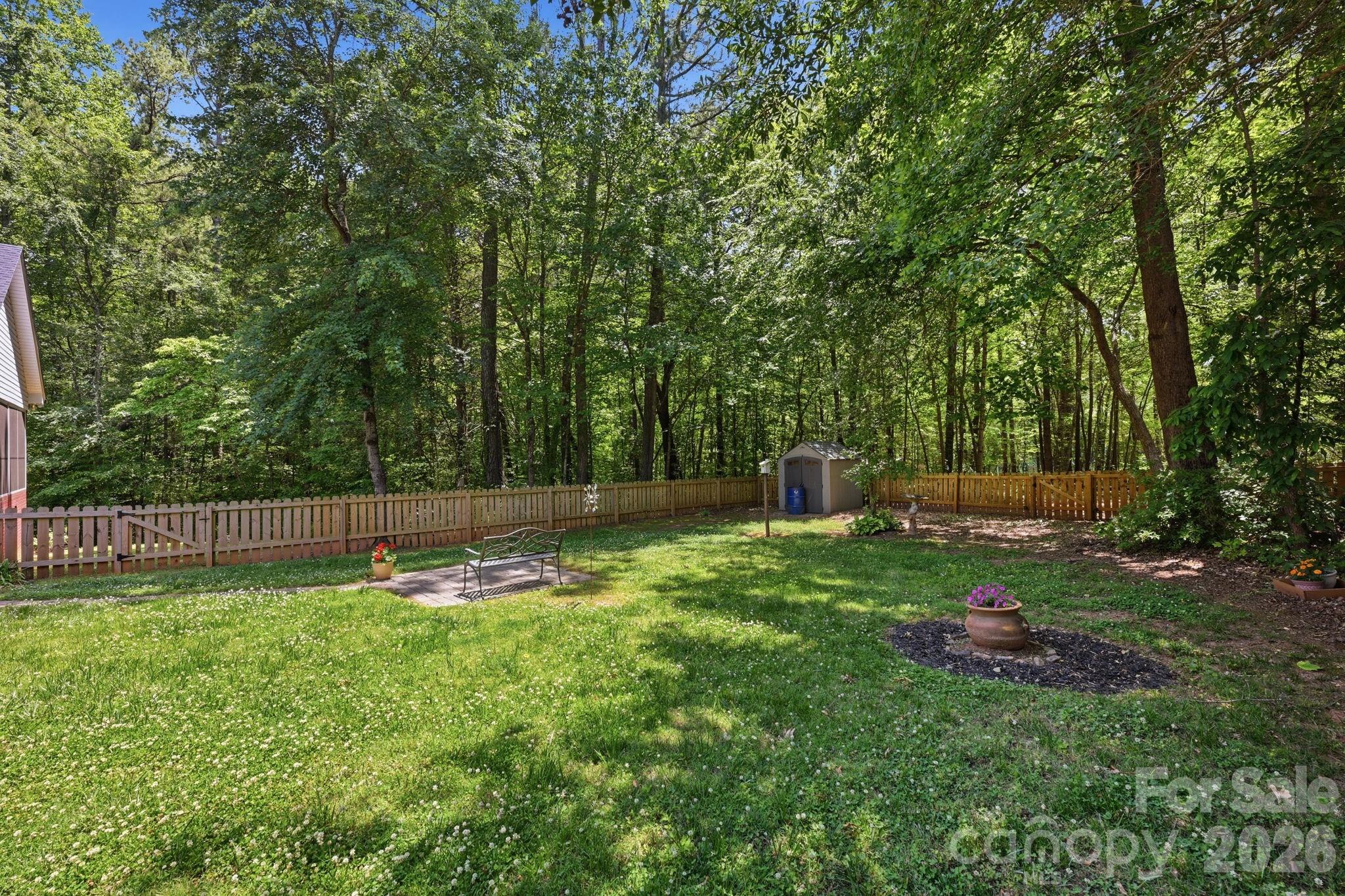 145 Upper Spencer Mountain Road Stanley, NC 28164 - Photo 27 of 29 a backyard of a house with lots of green space and fountain