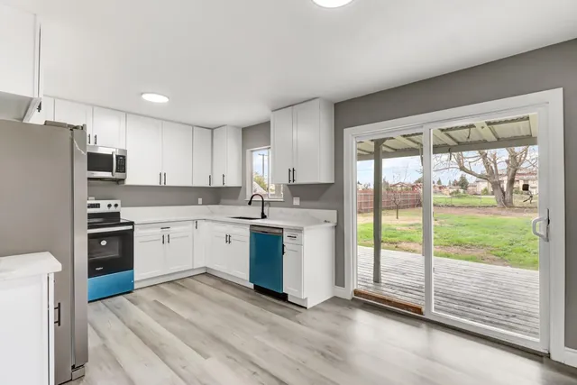 a kitchen with a refrigerator stove top oven and sink