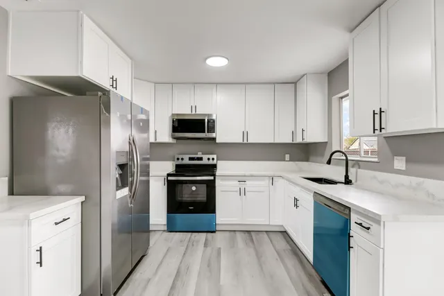 a kitchen with a refrigerator stove and sink