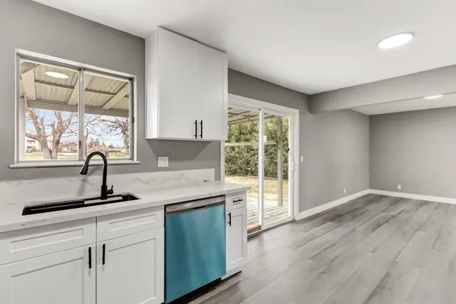 a kitchen with a sink and large window