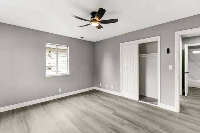 wooden floor in an empty room with a window