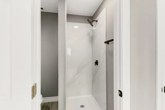 a bathroom with a glass shower door