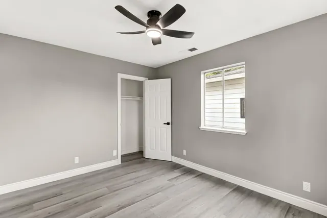 wooden floor in an empty room with a window