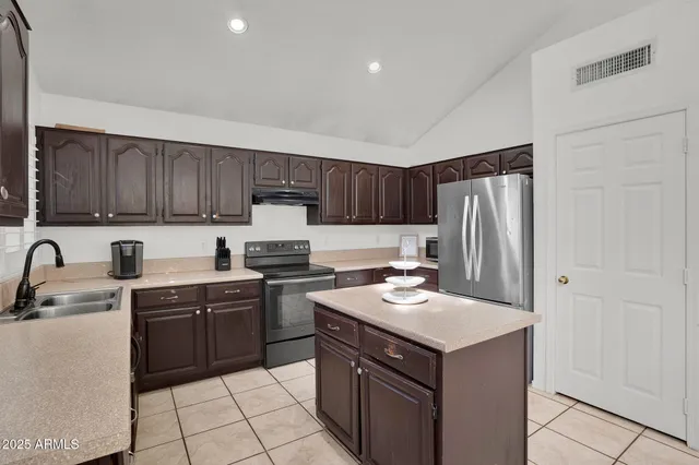 a living room with couches and a potted plant on a dresser
