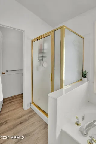 a bathroom with a granite countertop sink mirror bathtub and double