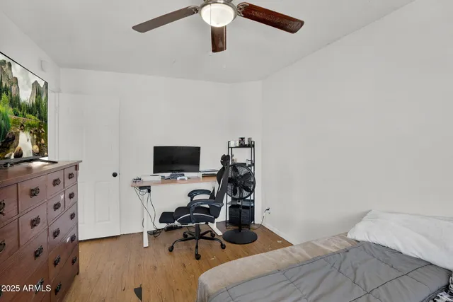 a bedroom with a bed and a flat screen tv