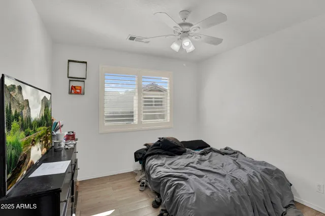 a bedroom with a bed dresser and a window
