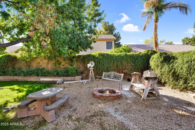 a backyard of a house with table and chairs