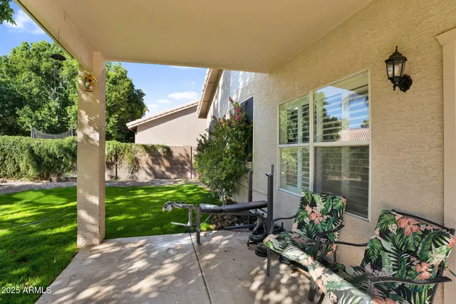 a view of a backyard with plants and outdoor seating