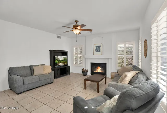 a view of a white house with a yard and plants