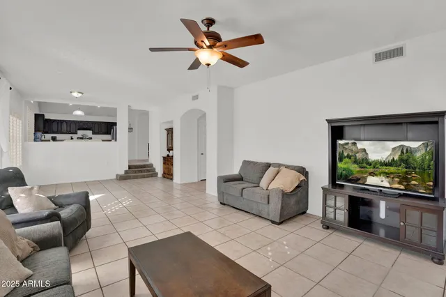 a living room with furniture a fireplace and a large window