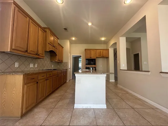 a kitchen with stainless steel appliances granite countertop a refrigerator oven a sink dishwasher and a microwave oven on the blue kitchen countertops