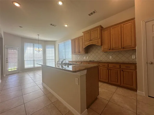 a kitchen with stainless steel appliances granite countertop a sink and cabinets