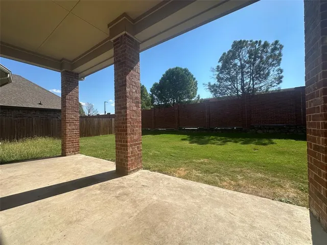 a large kitchen with granite countertop a stove a sink and a refrigerator