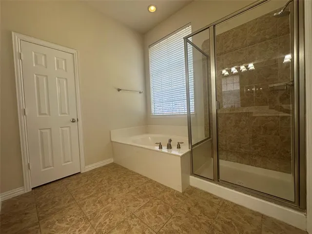 a spacious bathroom with a sink a large mirror and a shower