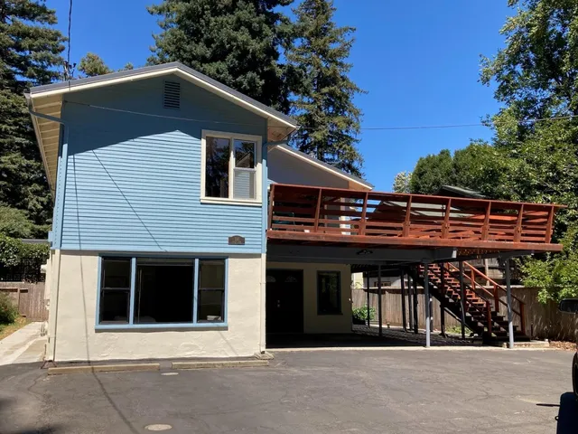a front view of a house with a garden