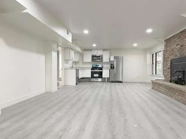 a view of kitchen with furniture and a refrigerator
