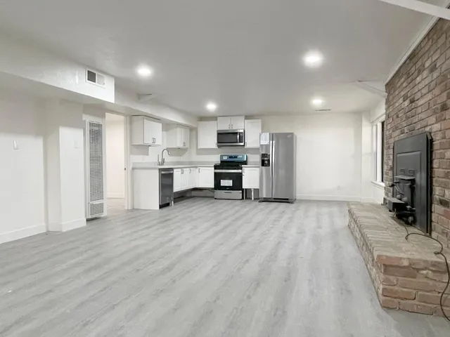 a view of a kitchen with a sink and cabinets