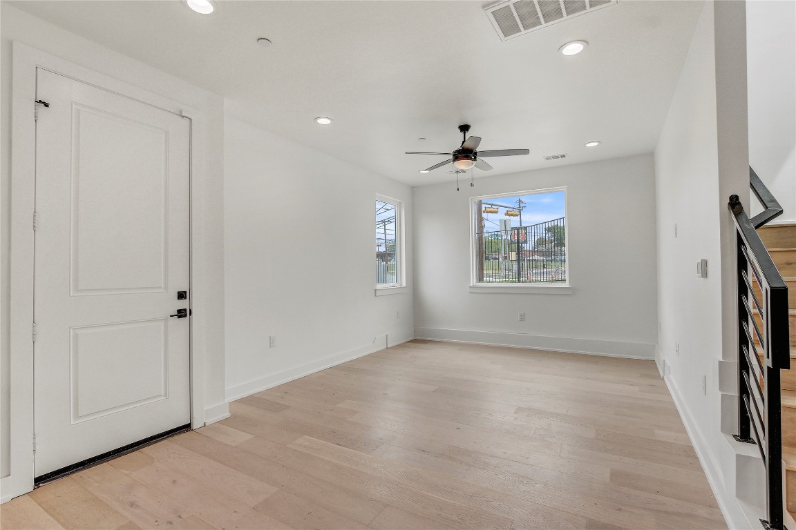 4127 East 12th Street, Unit 6 Austin, TX 78721 - Photo 12 of 17 Unfurnished living room with light wood-style floors, a ceiling fan, recessed lighting, and baseboards