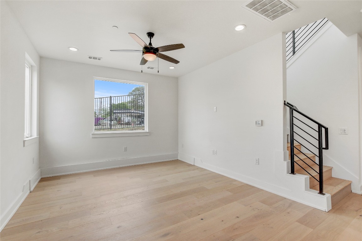 4127 East 12th Street, Unit 6 Austin, TX 78721 - Photo 13 of 17 Spare room with ceiling fan, light wood-style floors, stairs, recessed lighting, and baseboards