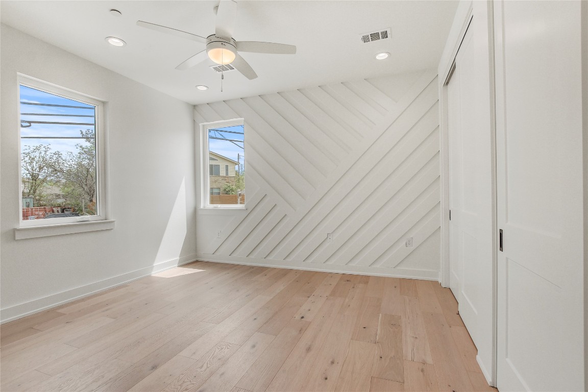 4127 East 12th Street, Unit 6 Austin, TX 78721 - Photo 16 of 17 Unfurnished room featuring light wood-type flooring, a ceiling fan, baseboards, and recessed lighting