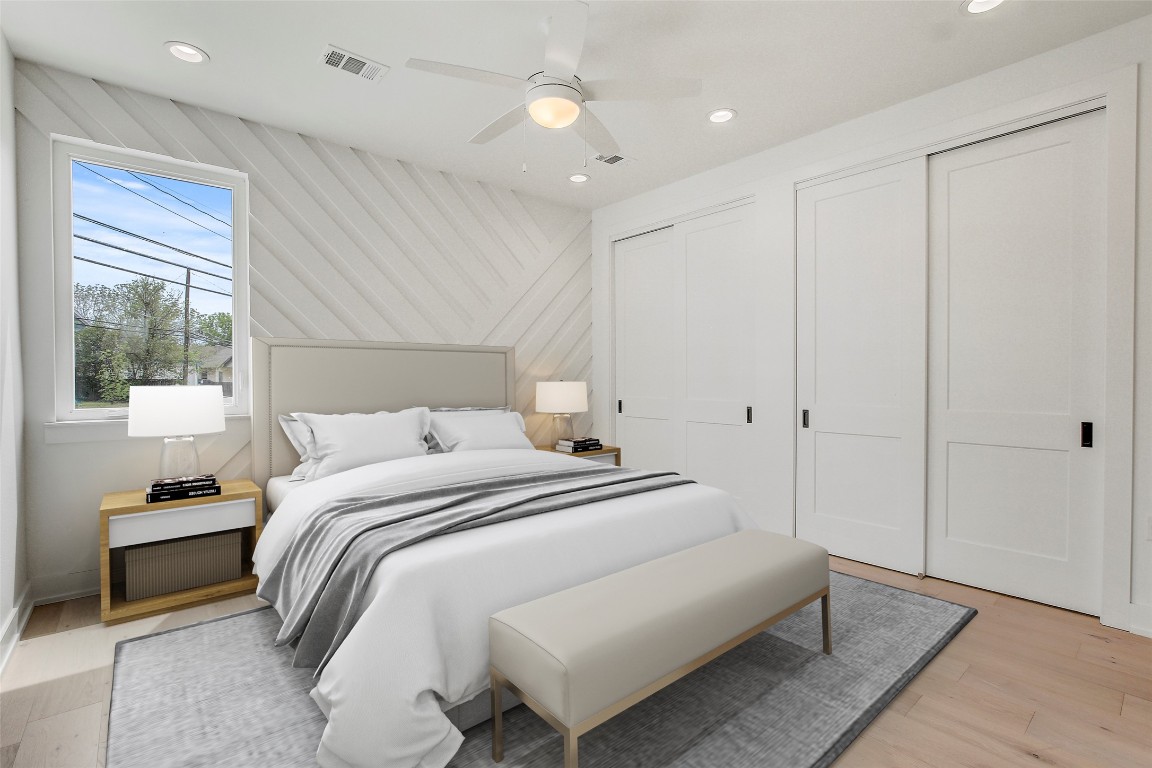 4127 East 12th Street, Unit 6 Austin, TX 78721 - Photo 6 of 17 Bedroom with multiple closets, recessed lighting, light wood-style floors, and a ceiling fan