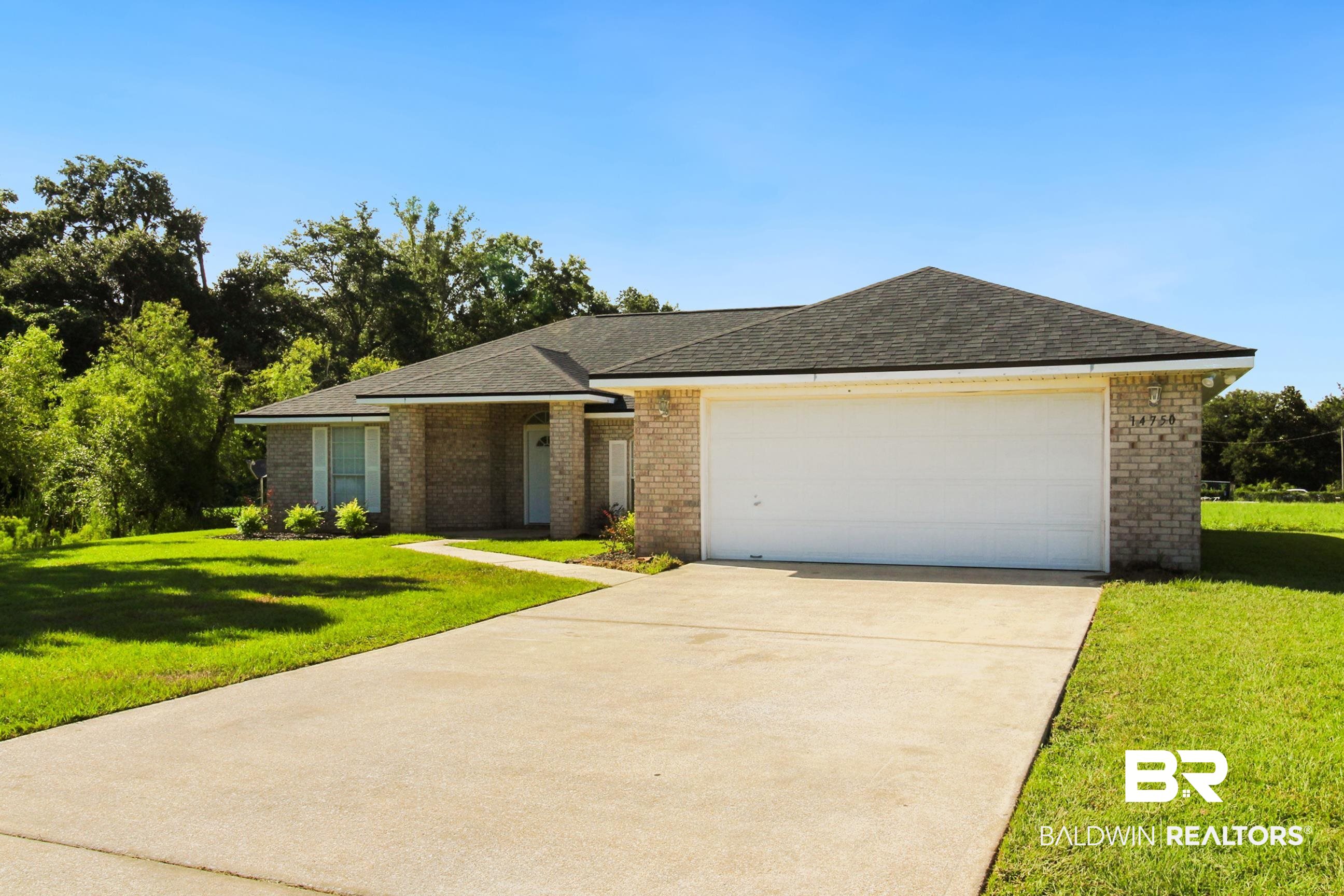 14750 Pawnee Court Foley, AL 36535 - Photo 5 of 34 Single story home with brick siding, concrete driveway, a front yard, and a garage