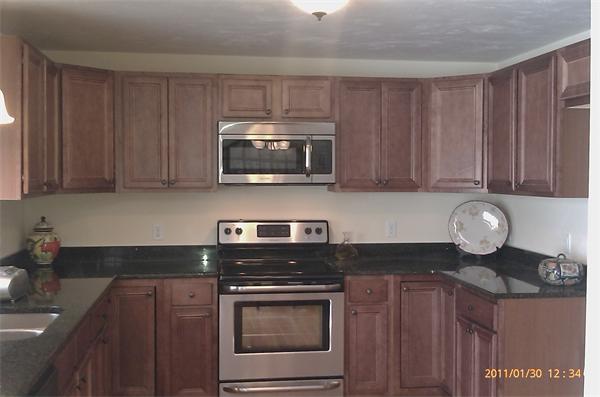 83 Massasoit Road Worcester, MA 01604 - Photo 2 of 10 a kitchen with granite countertop wooden cabinets and stainless steel appliances